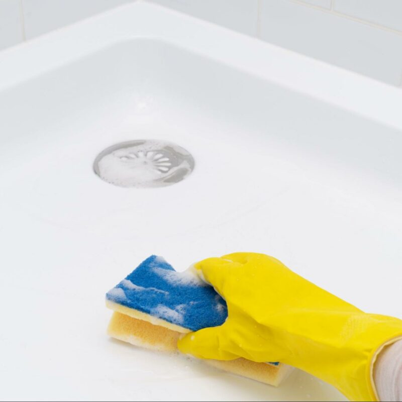 Cleaning a bath system with a non-abrasive sponge for maintenance and longevity.