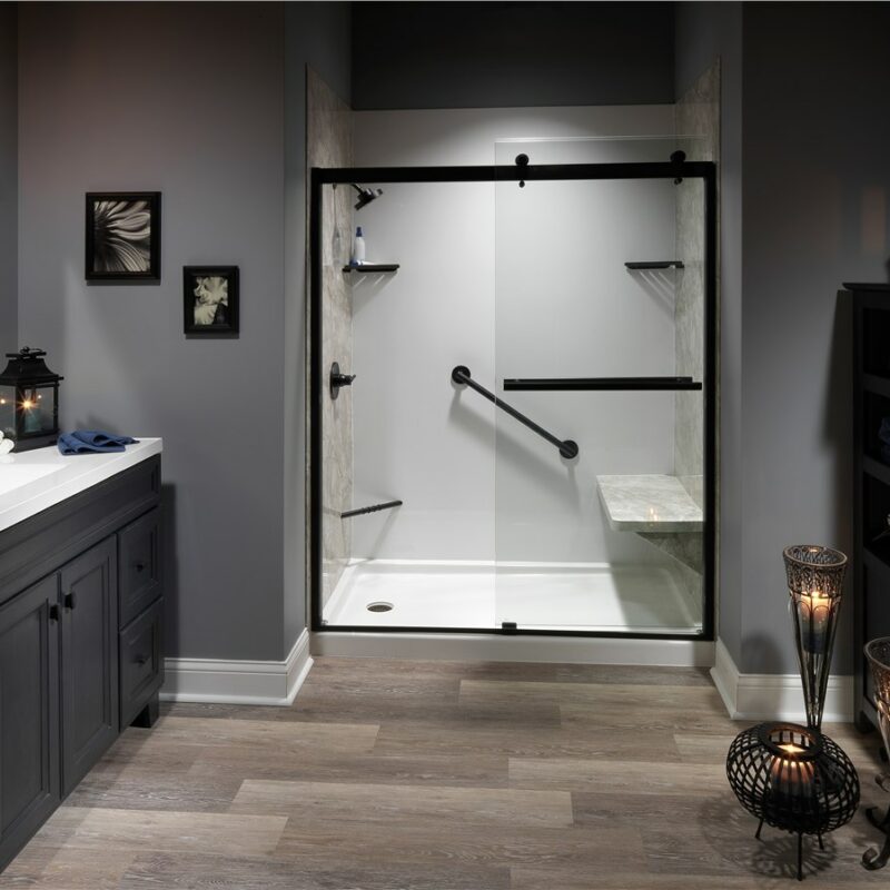 Luxurious bathroom remodel featuring a sleek black and gray color scheme with a glass-enclosed shower, modern fixtures, and ambient lighting.